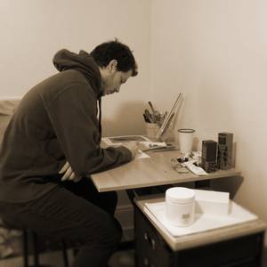 Robert Filiuta drawing at his studio desk